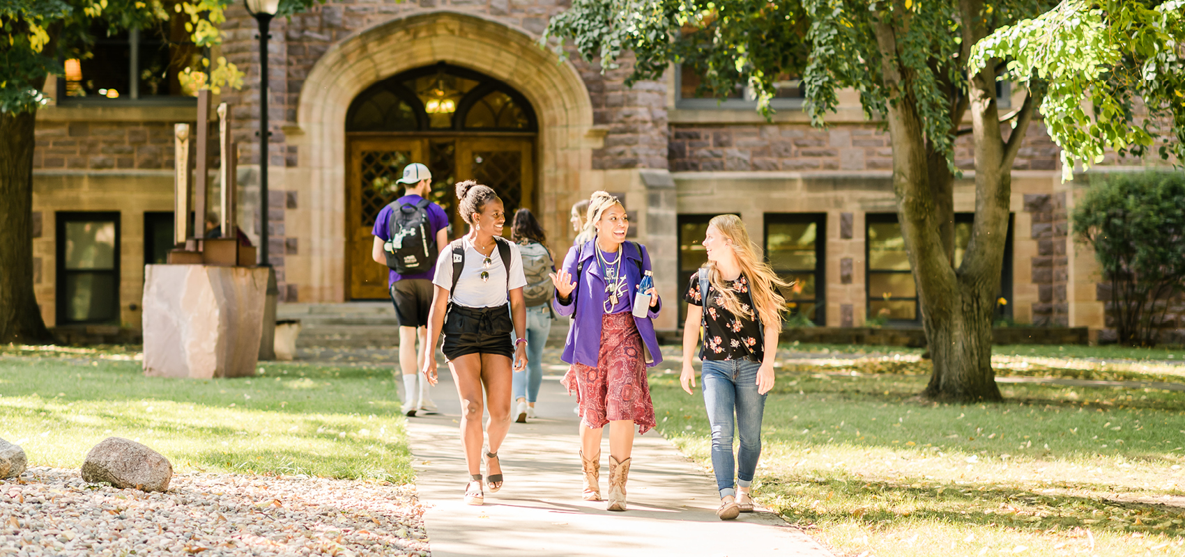 Five students in front of Jorden Hall on USF's campus.