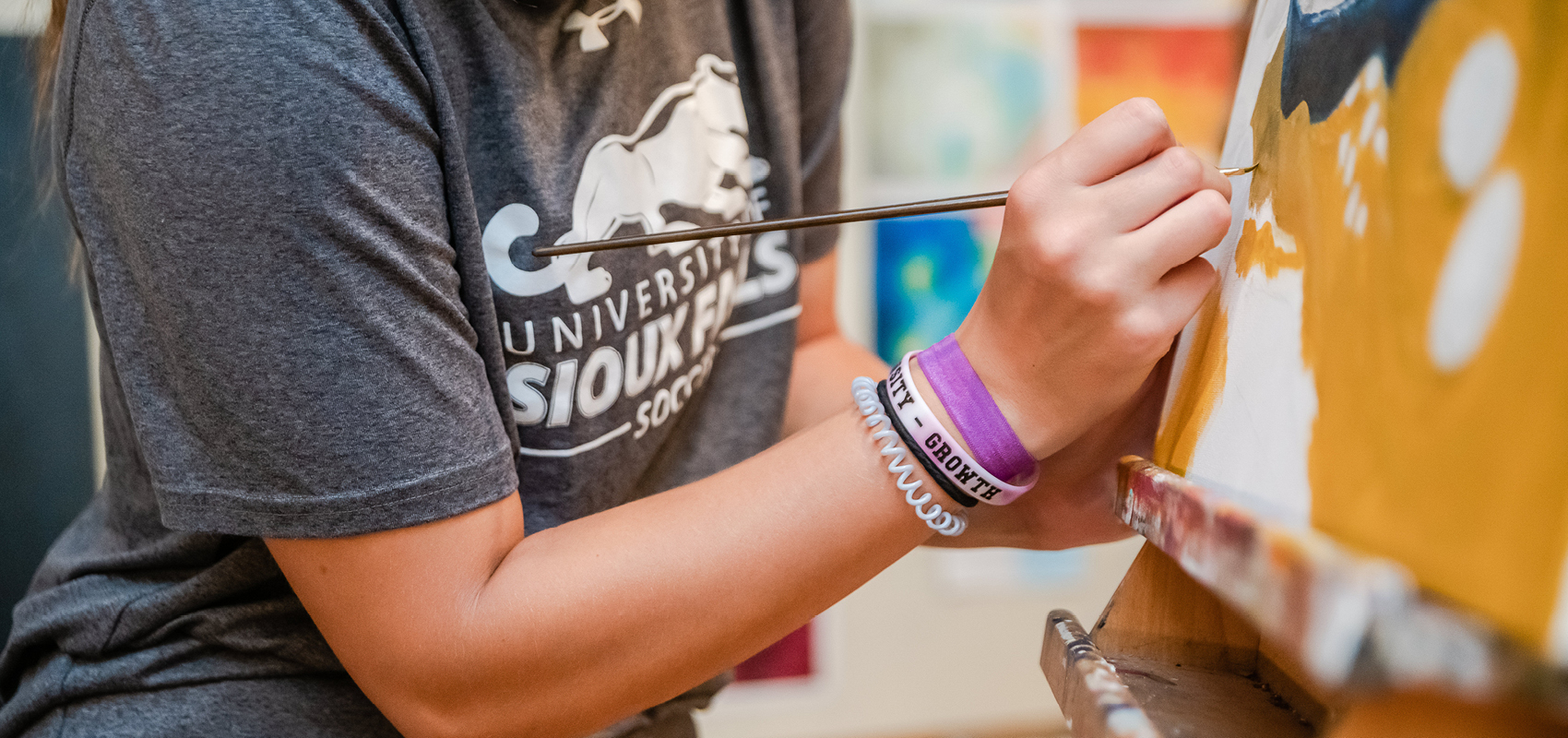 USF female student painting during art class.