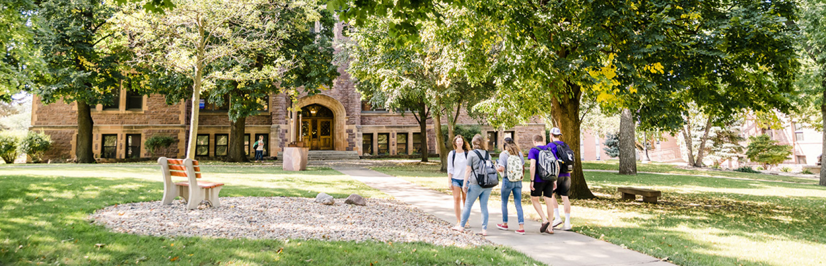 Students walking through campus in the fall.