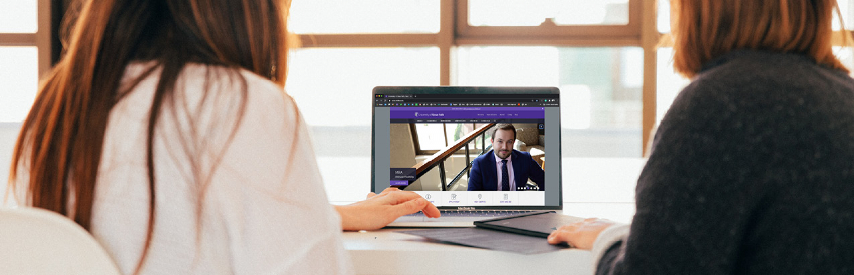 two women viewing USF Online Programs