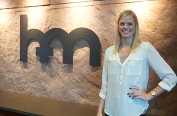 Woman standing in front of logo